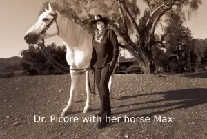 Dr. Dana Picore, CEO of a security consulting company, standing outdoors beside her horse Max.